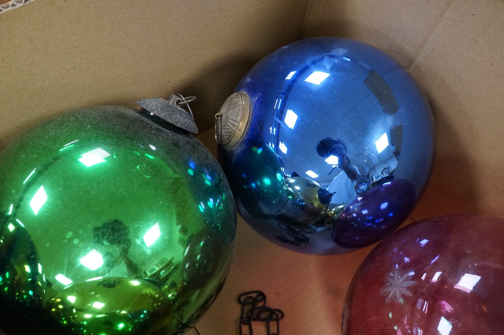A collection of coloured circular and grape shaped glass witches balls and decorations, largest grape decoration 40cm in length